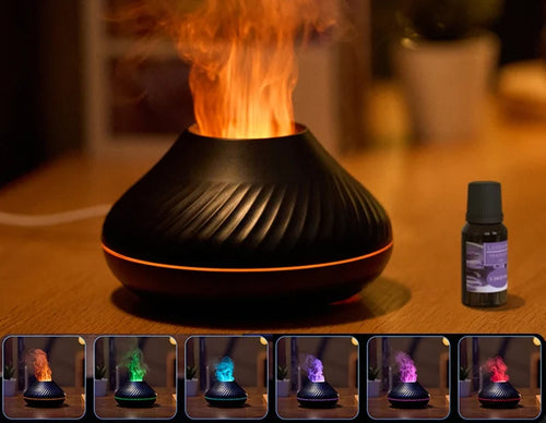 Diffuseur BRAISE Volcan noir, flamme orange et flacon d'huile essentielle sur une table en bois